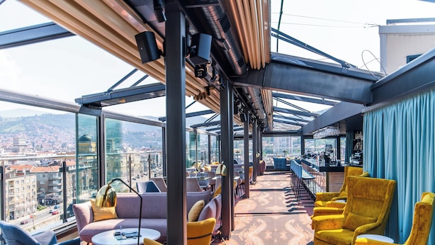A rooftop bar with seating and a view of the city. - Courtyard by Marriott Sarajevo (Sarajevo)
