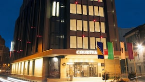 A Courtyard Marriott hotel with a modern facade, large windows, and a visible entrance. - Courtyard by Marriott Sarajevo (Sarajevo)