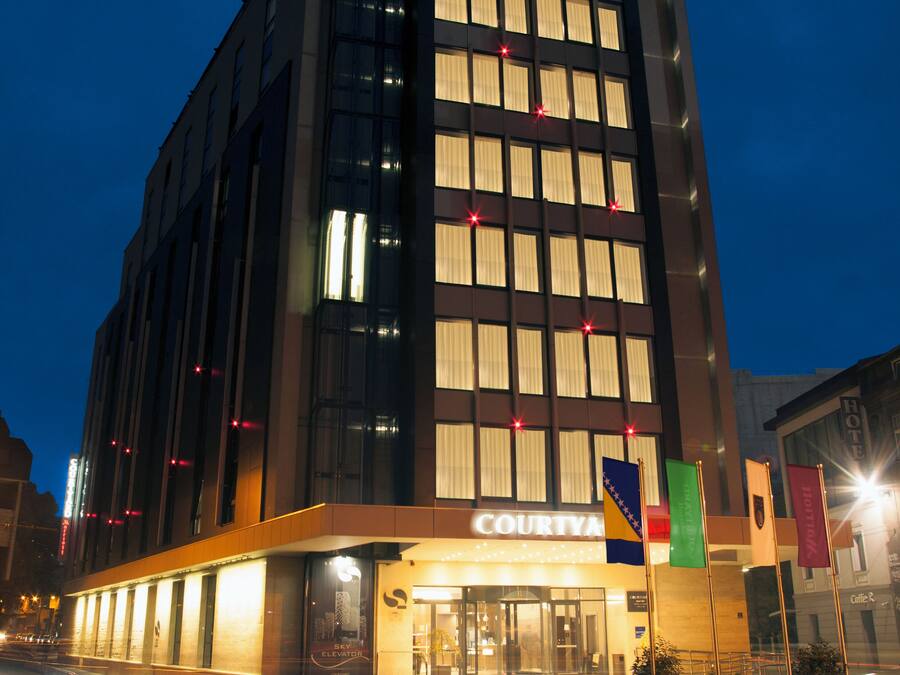 A Courtyard Marriott hotel with a modern facade, large windows, and a visible entrance.