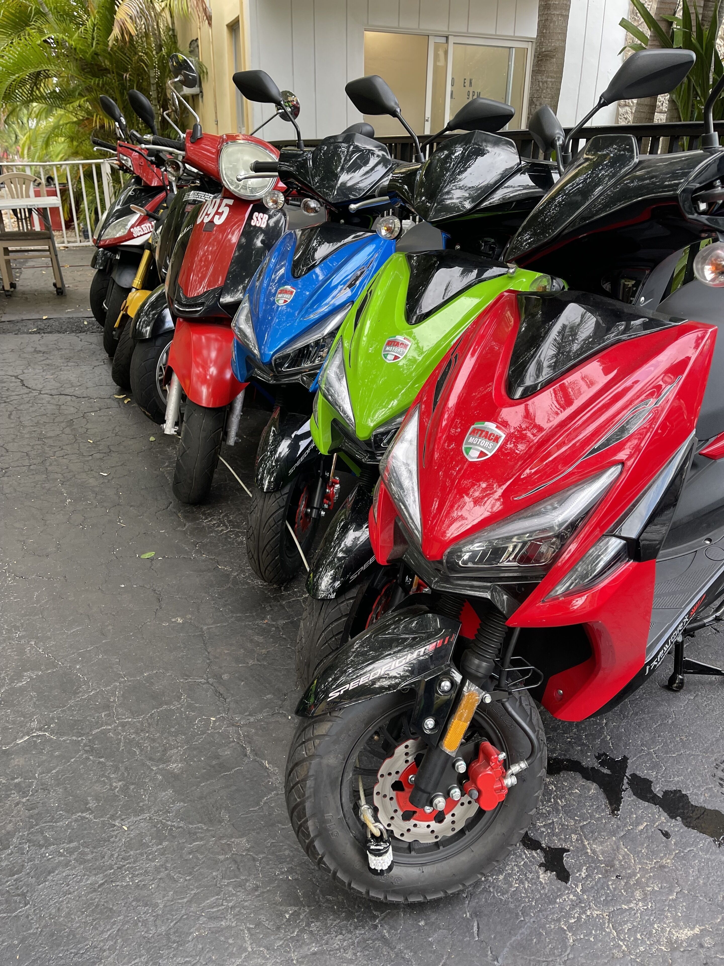 A row of motorcycles parked in a lot.