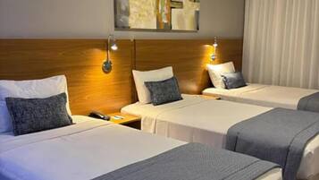 Deluxe Triple Room | Minibar, in-room safe, desk, soundproofing