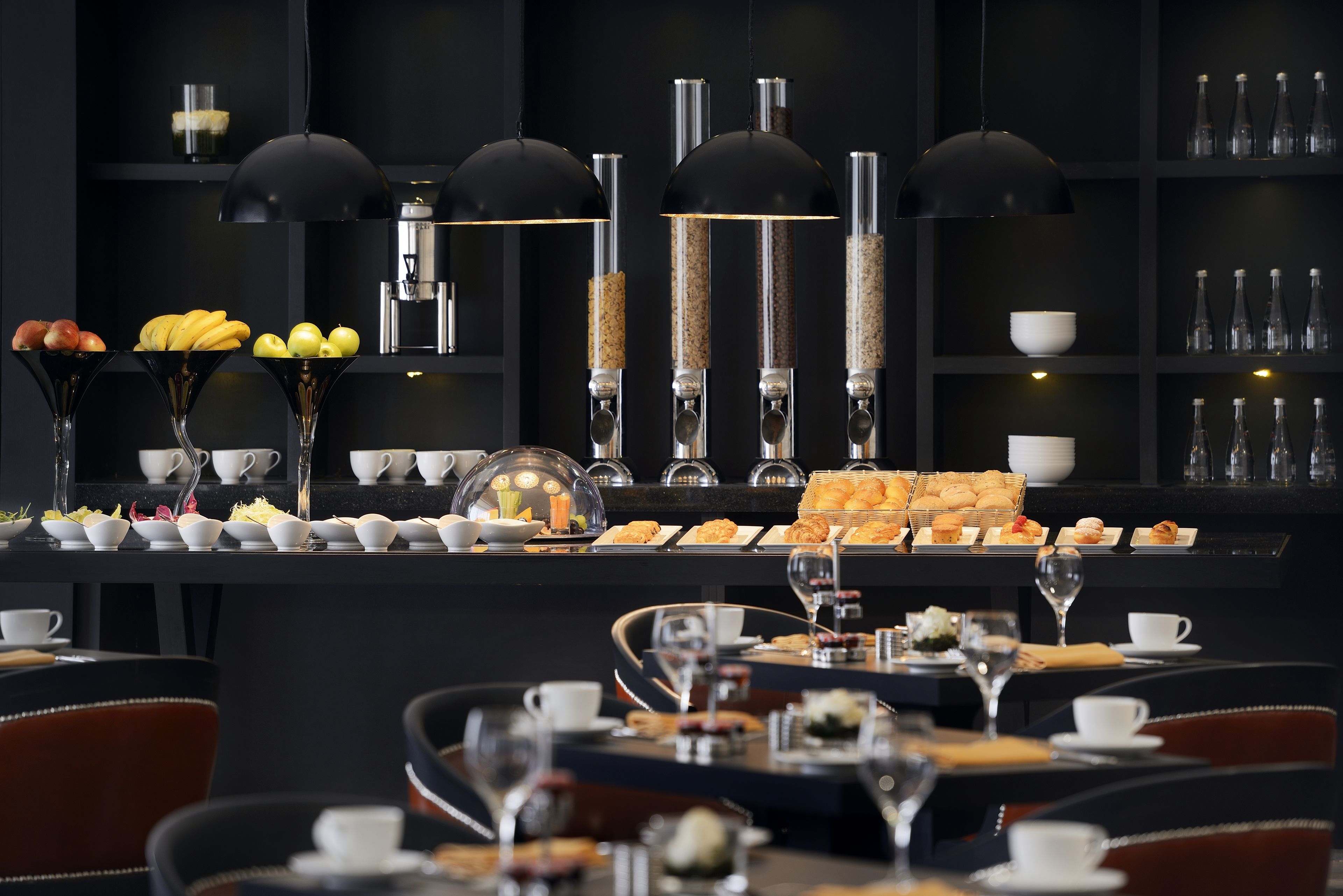 A breakfast buffet with various food items and a coffee station.