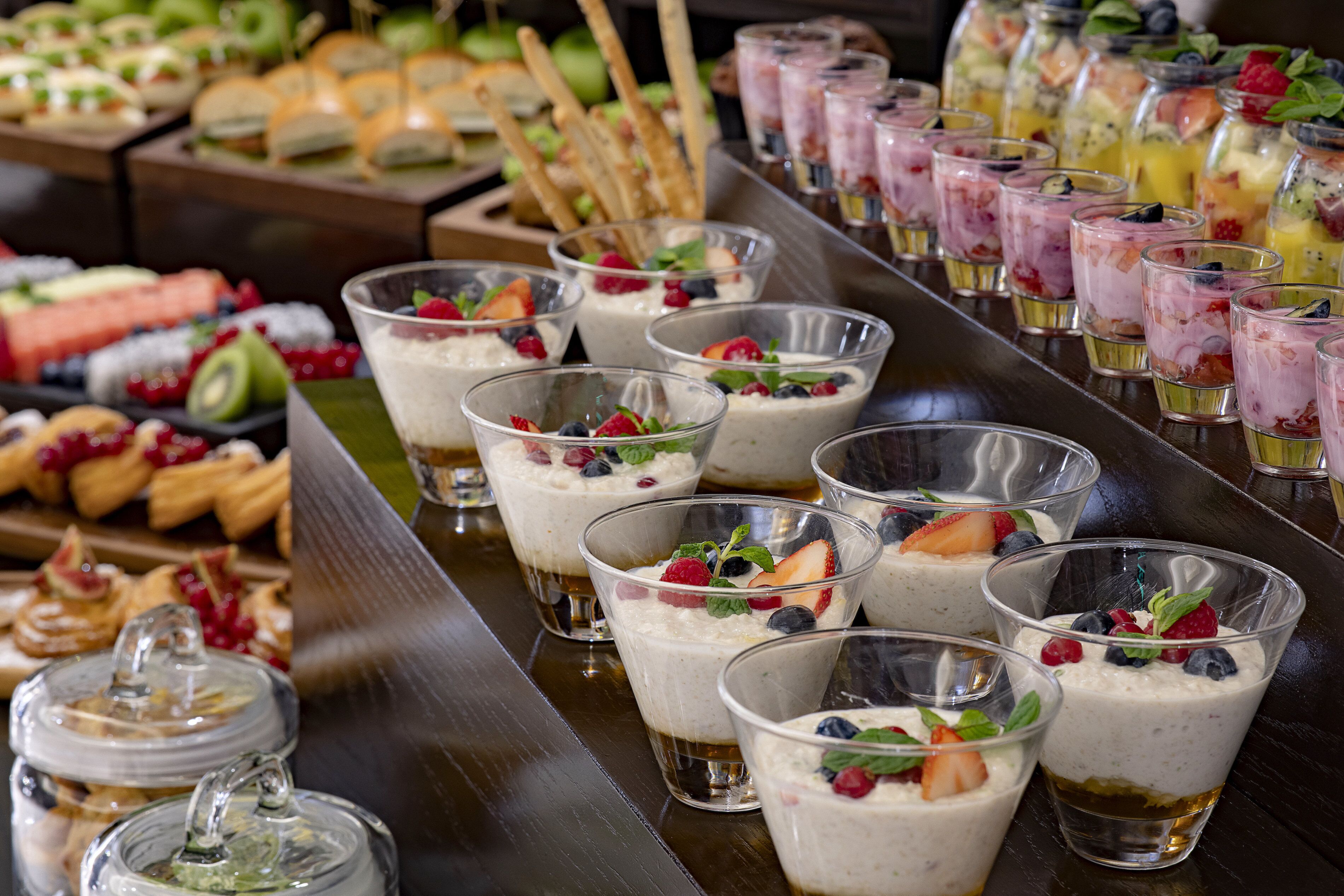 A buffet with various food items including desserts and beverages.