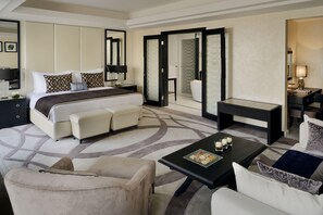 A modern hotel room with a large bed, a sofa, a coffee table, and a desk. - voco Riyadh by IHG (Riyadh)