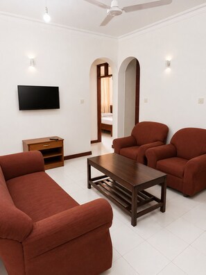 Family Apartment, 2 Bedrooms, Balcony, Pool View | Living area | 40-inch flat-screen TV with satellite channels, TV - Prestige Leisure Hotel (Mtwapa)