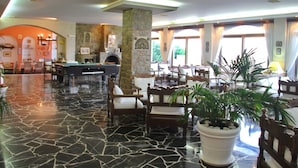A spacious lobby with a pool table, comfortable seating, and a stone fireplace. - Maragakis Beach Hotel (Hersonissos)