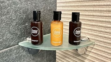 Three bottles of Central Hotels products on a glass shelf.
