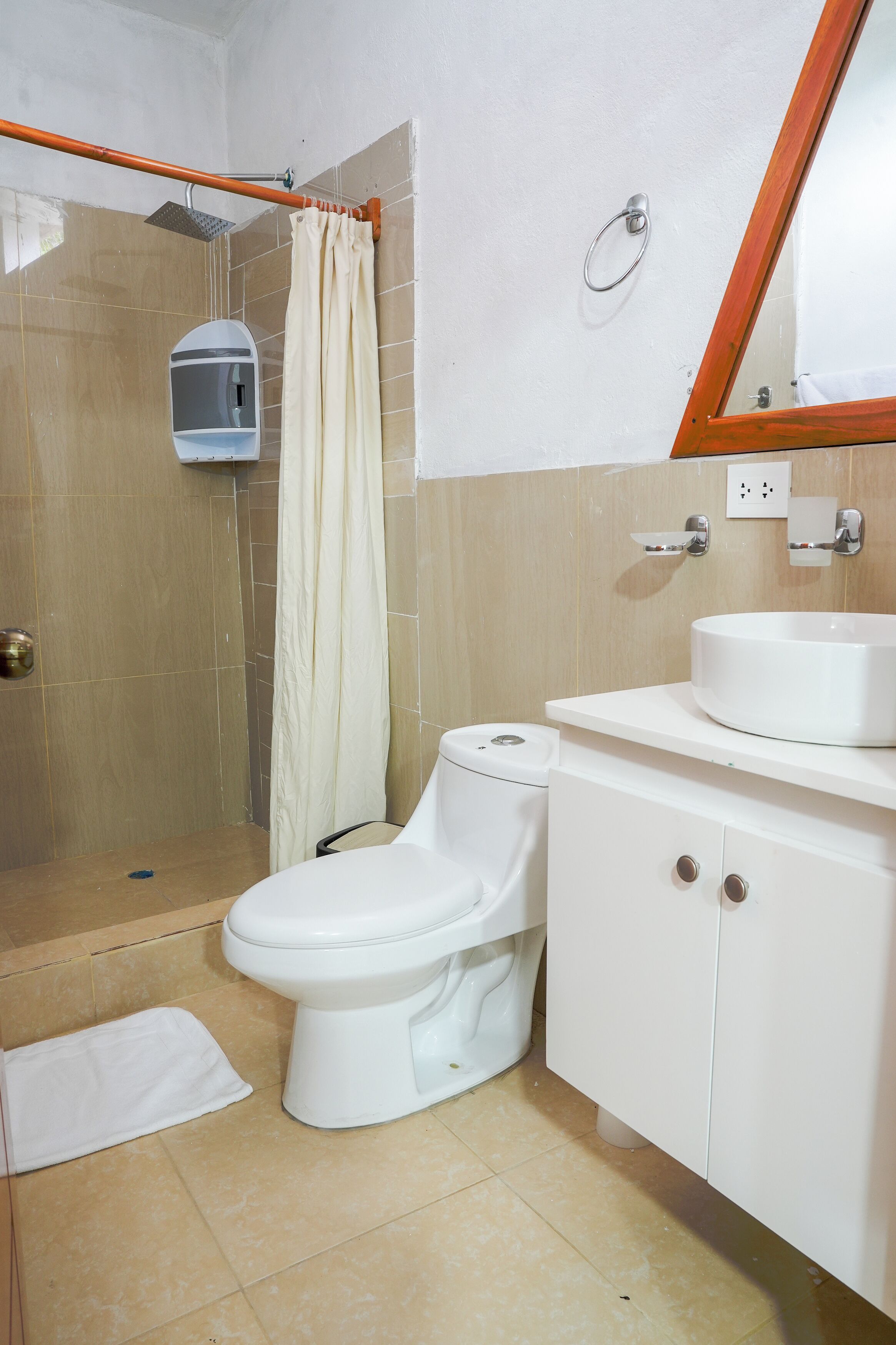 A bathroom with a shower, toilet, and sink.