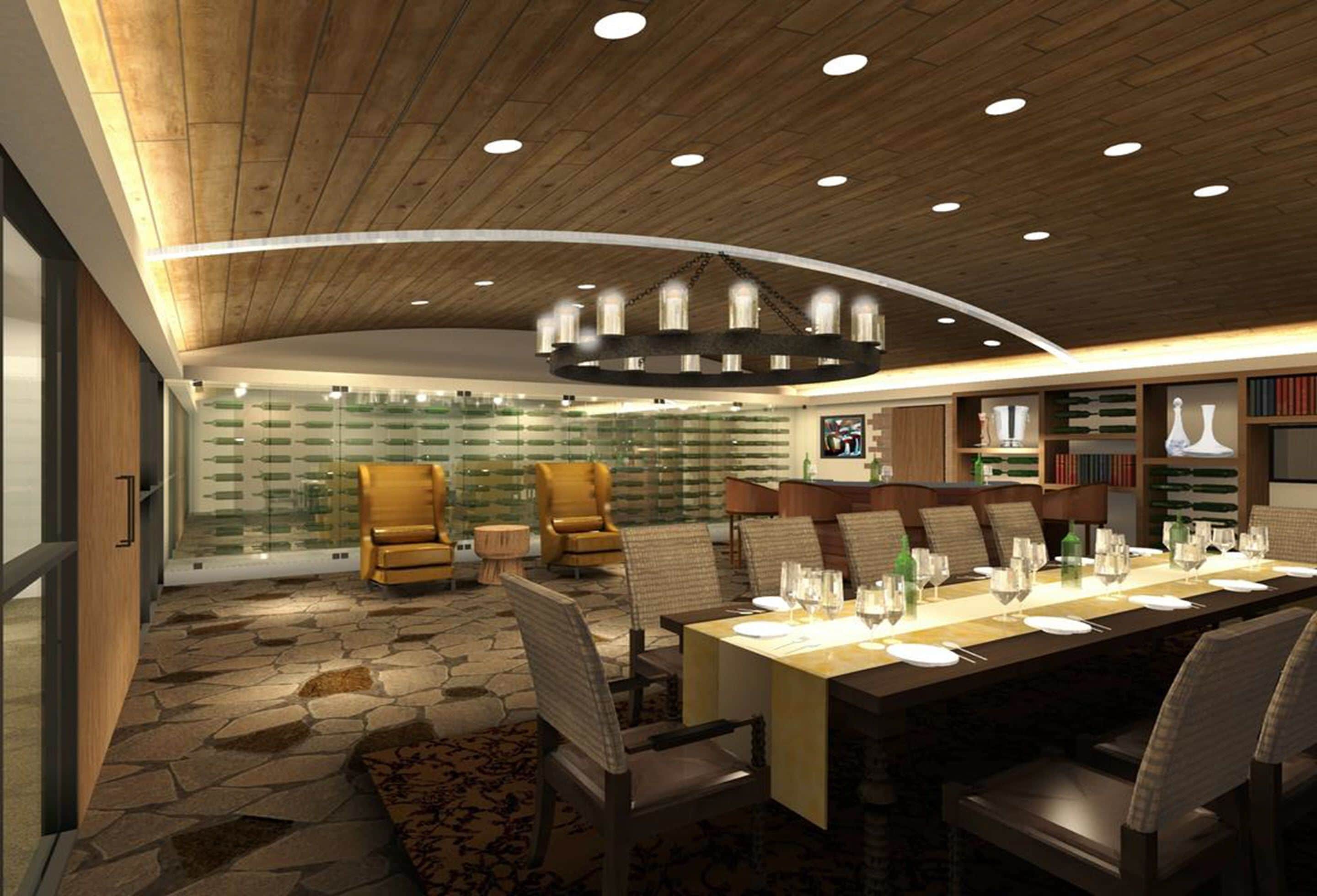 A modern dining area with a long table set for a meal, surrounded by comfortable seating.