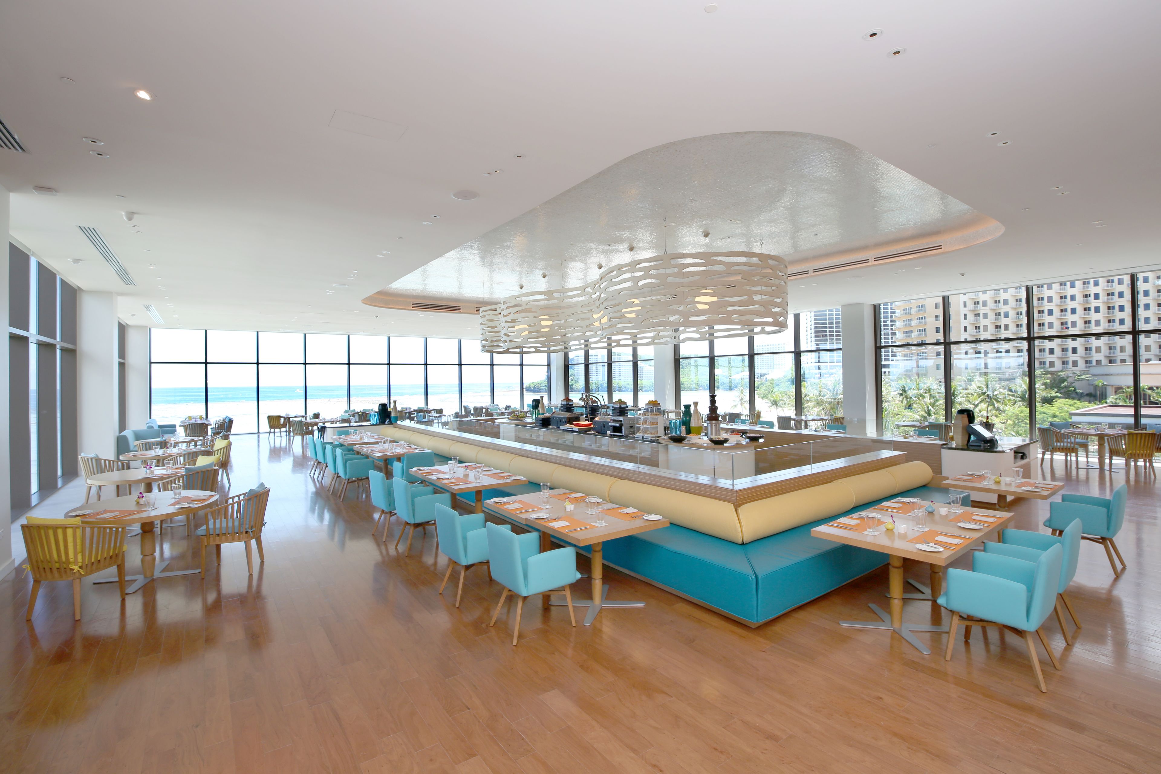 A spacious dining area with a long counter and multiple seating arrangements.