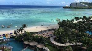 A resort with a beach, a pool area, and a view of the ocean.