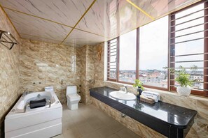 Separate tub and shower, hydromassage showerhead, designer toiletries