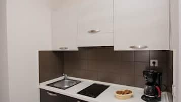 Full-size fridge, stovetop, coffee/tea maker, cookware/dishes/utensils