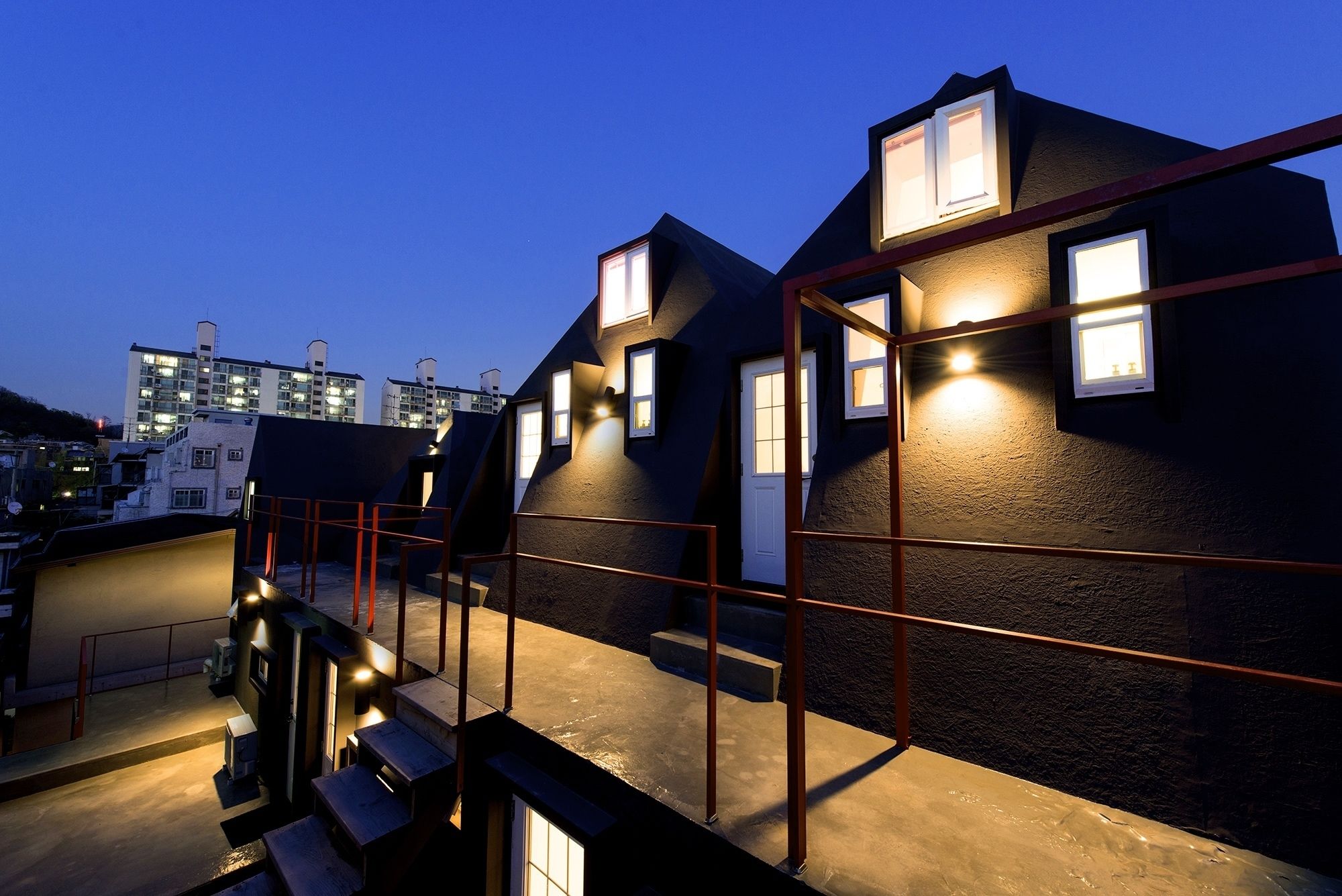 A modern residential building with multiple levels and a staircase.