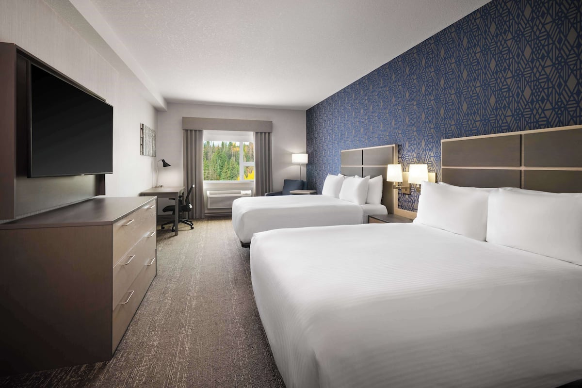 Premium bedding, desk, laptop workspace, blackout drapes
