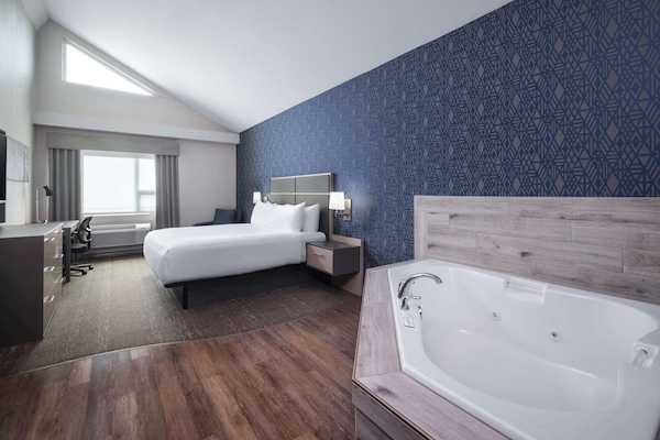 Premium bedding, desk, laptop workspace, blackout drapes