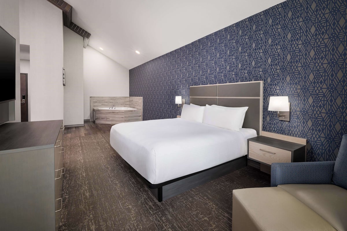 Premium bedding, desk, laptop workspace, blackout drapes