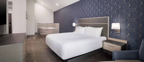 Premium bedding, desk, laptop workspace, blackout drapes