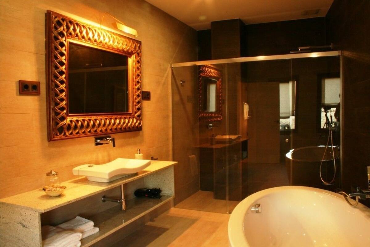 suite | bathroom | separate bathtub and shower, hair dryer, slippers, bidet