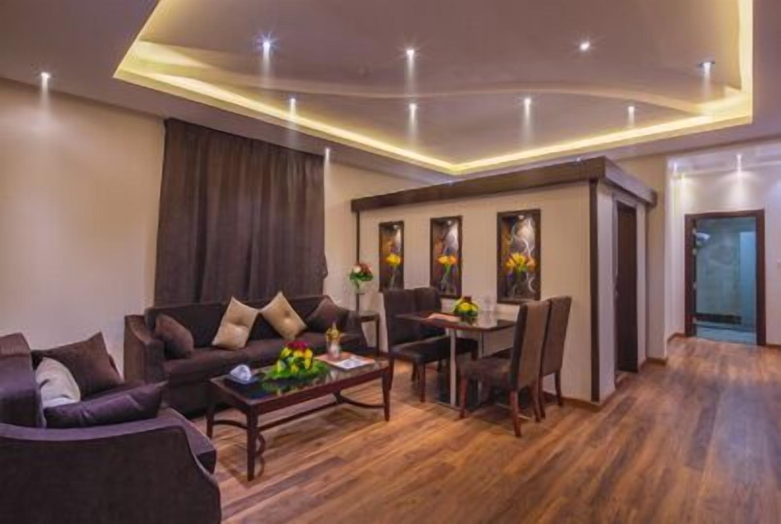A modern living room with a sofa, coffee table, and dining area.