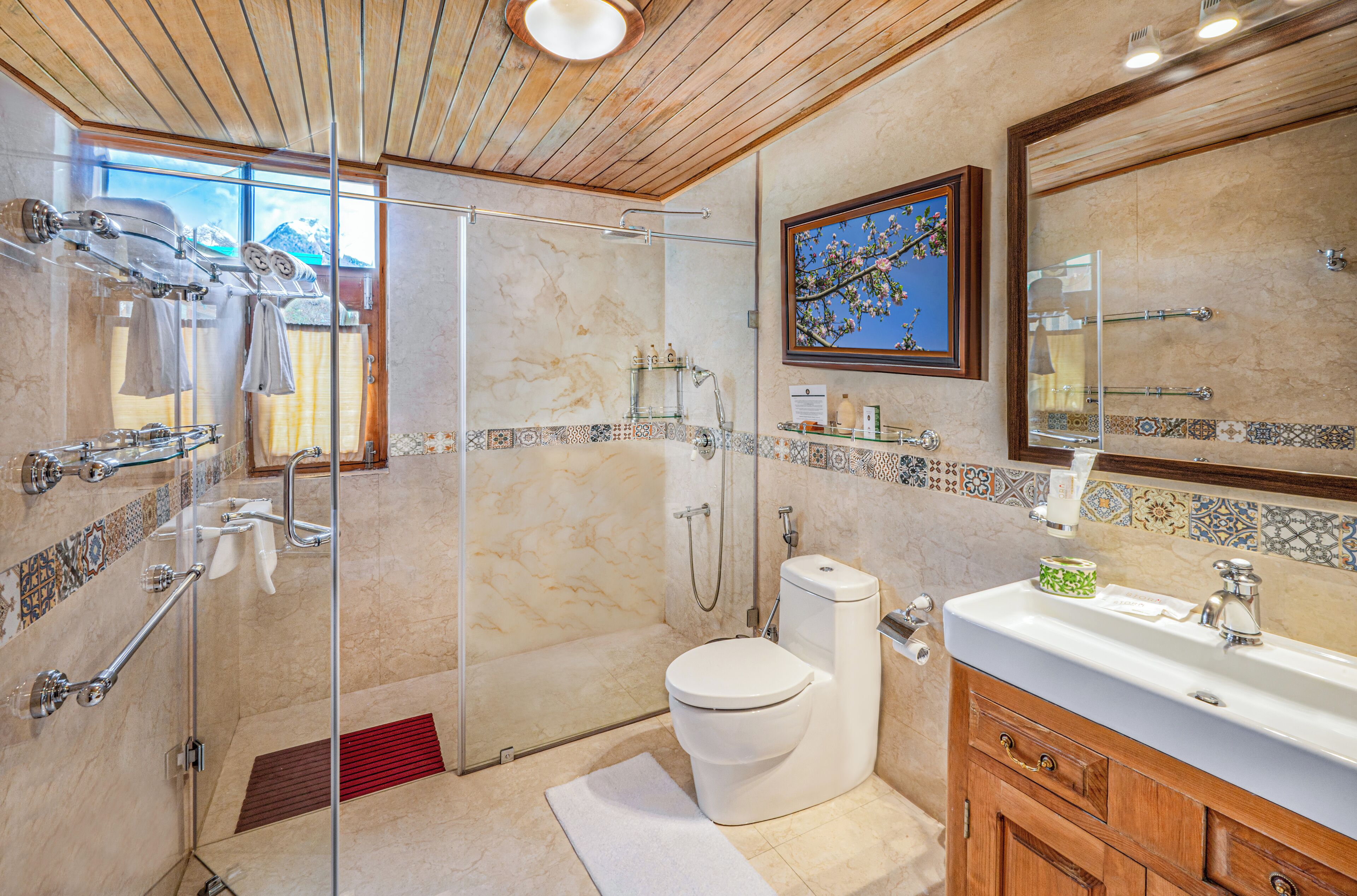 A modern bathroom with a glass-enclosed shower, a toilet, and a vanity with a sink.