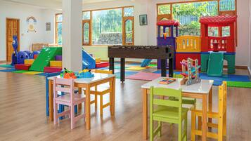 Children can play and socialize in this lively room with a playhouse, foosball table, and colorful furniture.