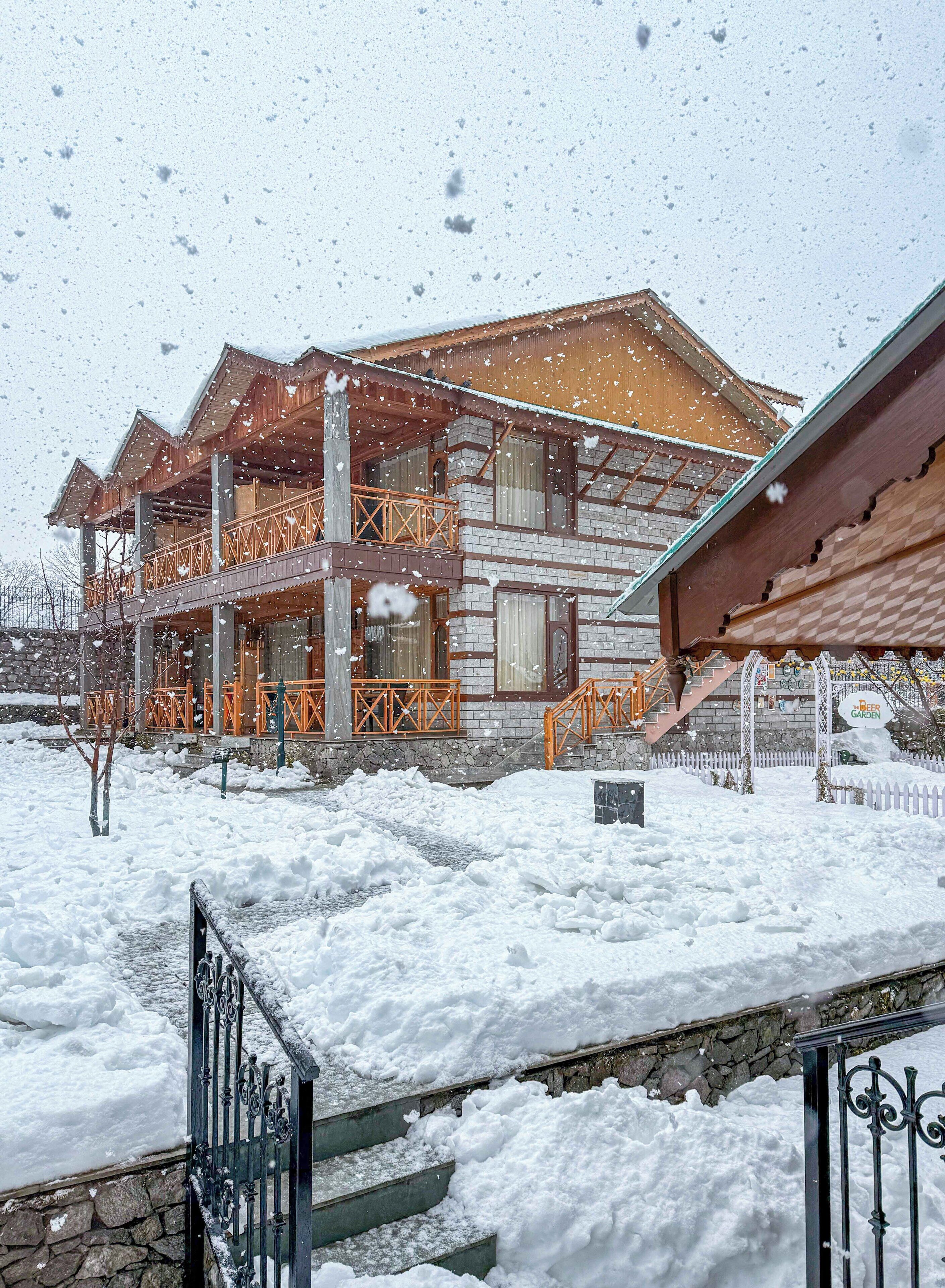 A wooden building with a balcony and a sign that reads "Beer Garden".