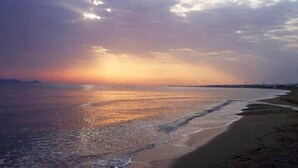 A beach with a sunset over the water. - Akti Corali (Malevizi)