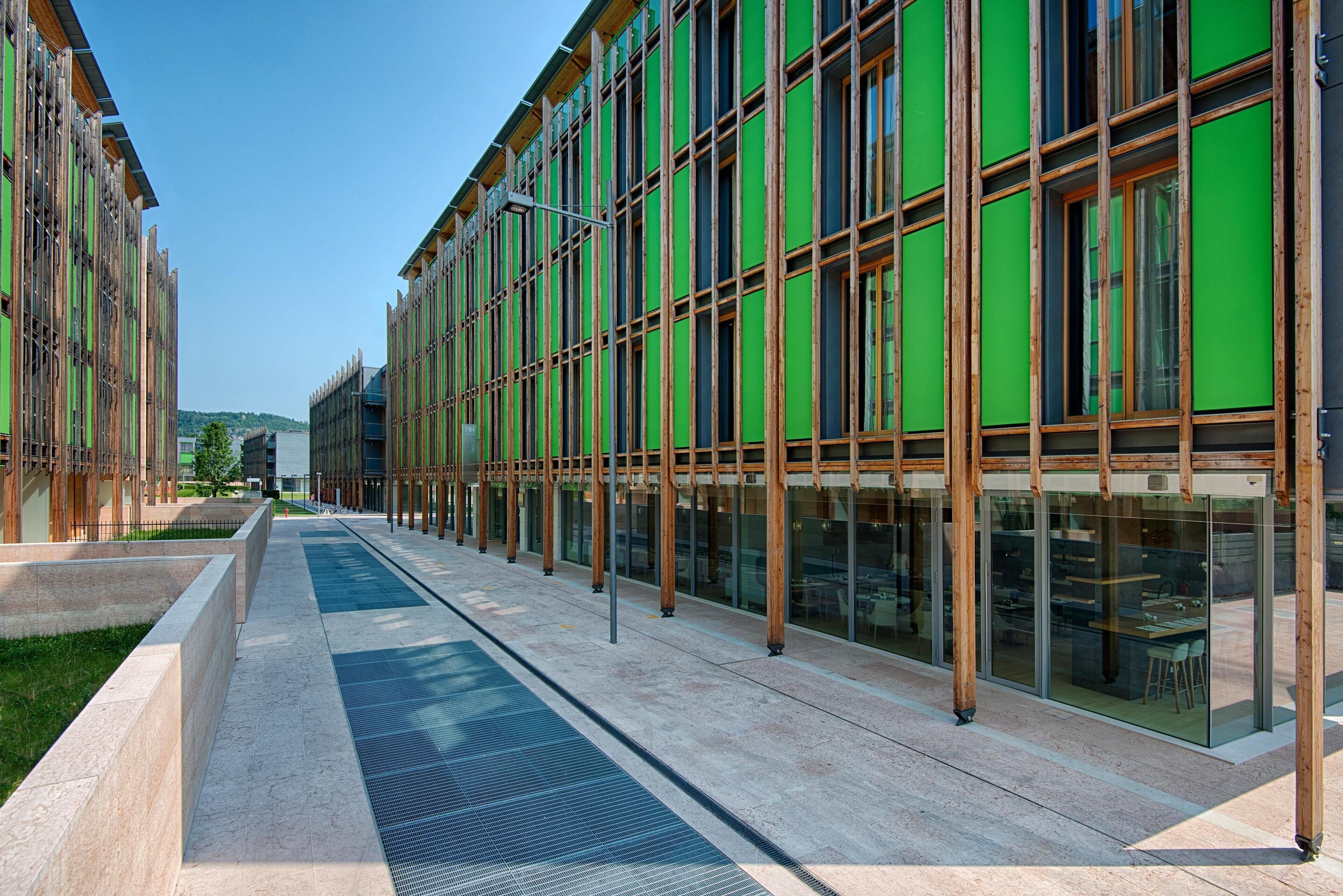 A modern building with large windows and a covered walkway.