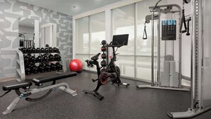 A gym with exercise equipment, a bench, dumbbells, and a red exercise ball. - Home2 Suites by Hilton Knoxville West (Knoxville)