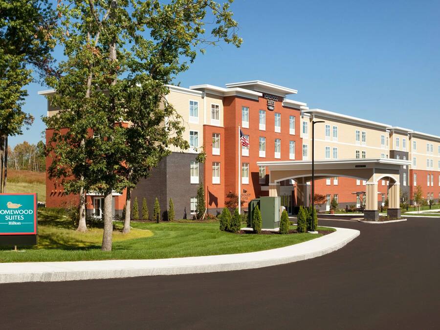 A hotel with a brick facade, multiple windows, and a covered entrance.