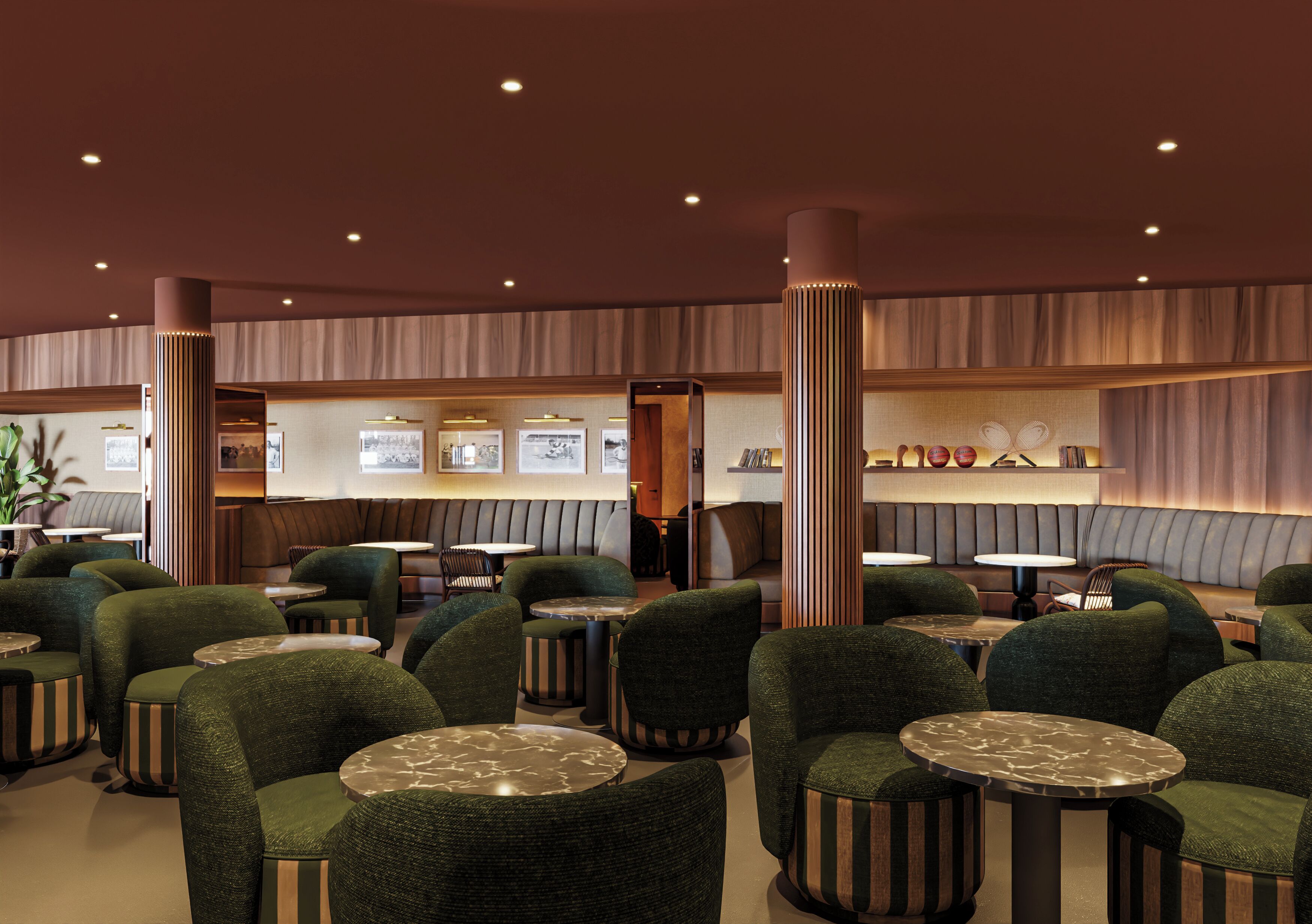 A modern interior with green upholstered chairs and round tables, recessed ceiling lighting, and a wall with framed artwork.
