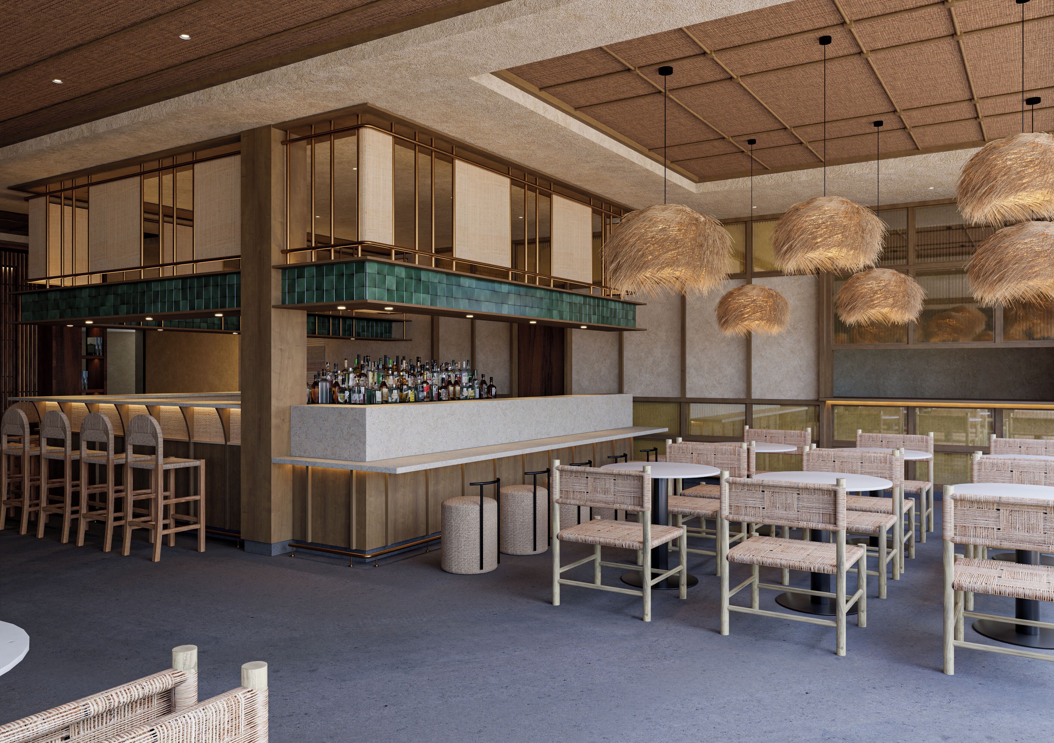 A bar area with a long counter, multiple chairs, and hanging light fixtures.