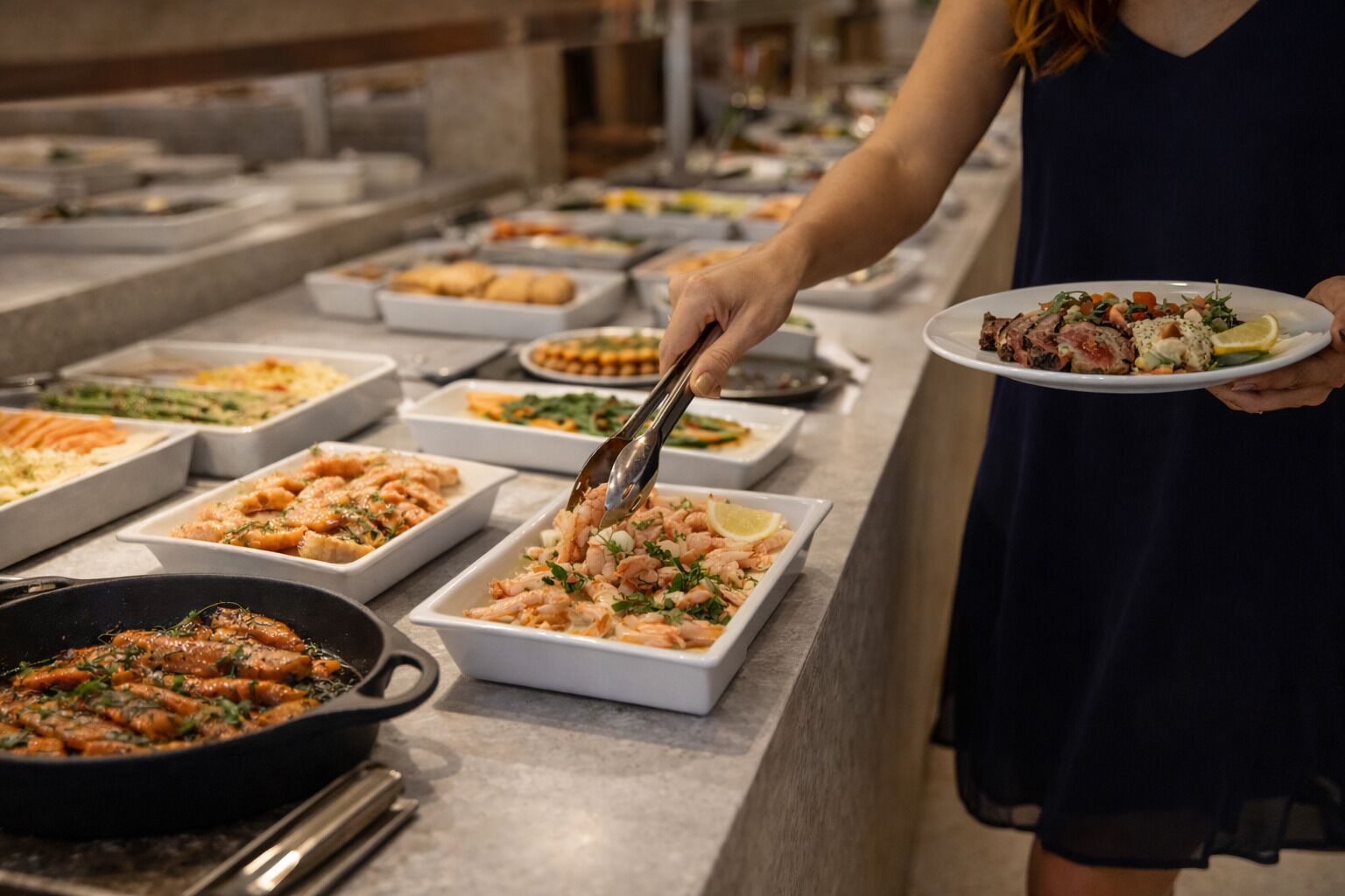 A buffet with various dishes, including seafood and salads.