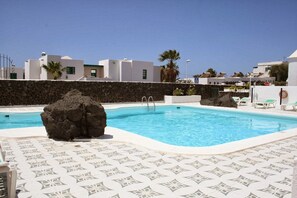 Piscine extérieure, parasols, chaises longues