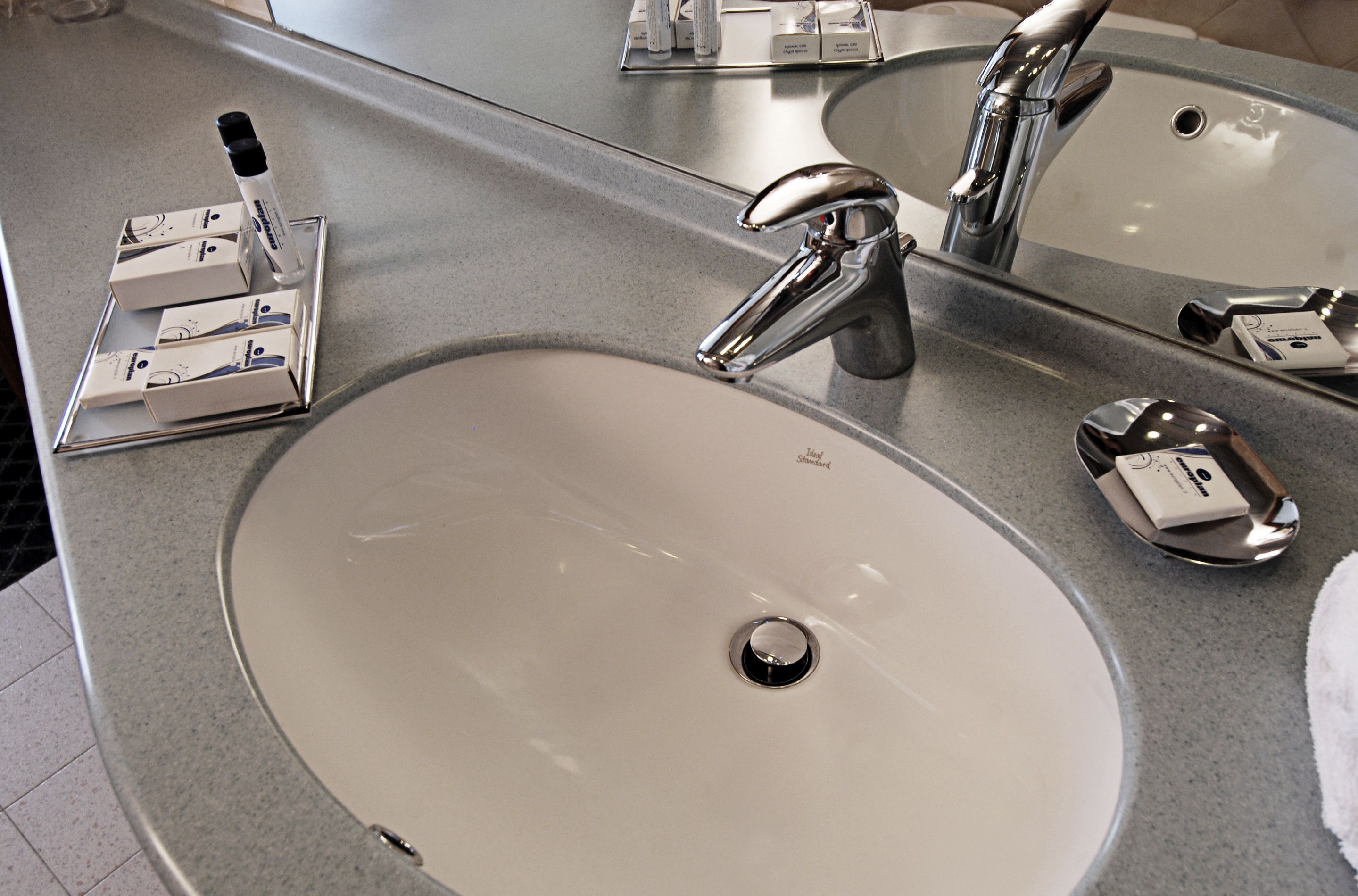 economy double room, multiple beds | bathroom sink