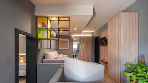 A modern interior with a sofa, a coffee table, and a wooden cabinet. - NataLis Apartamentos (Pajara)