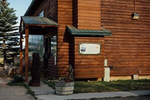 A wooden cabin with a sign reading "Office Register." - Teton Peaks Resort (Tetonia)
