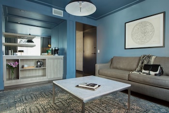 Hotel amenities such as safe, desk and work area at The Tillary Hotel