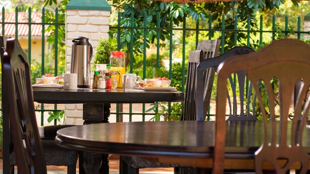 A table set for breakfast with a coffee pot, a jug, and a plate of food. - Wild Trekkers Lodge (Victoria Falls)