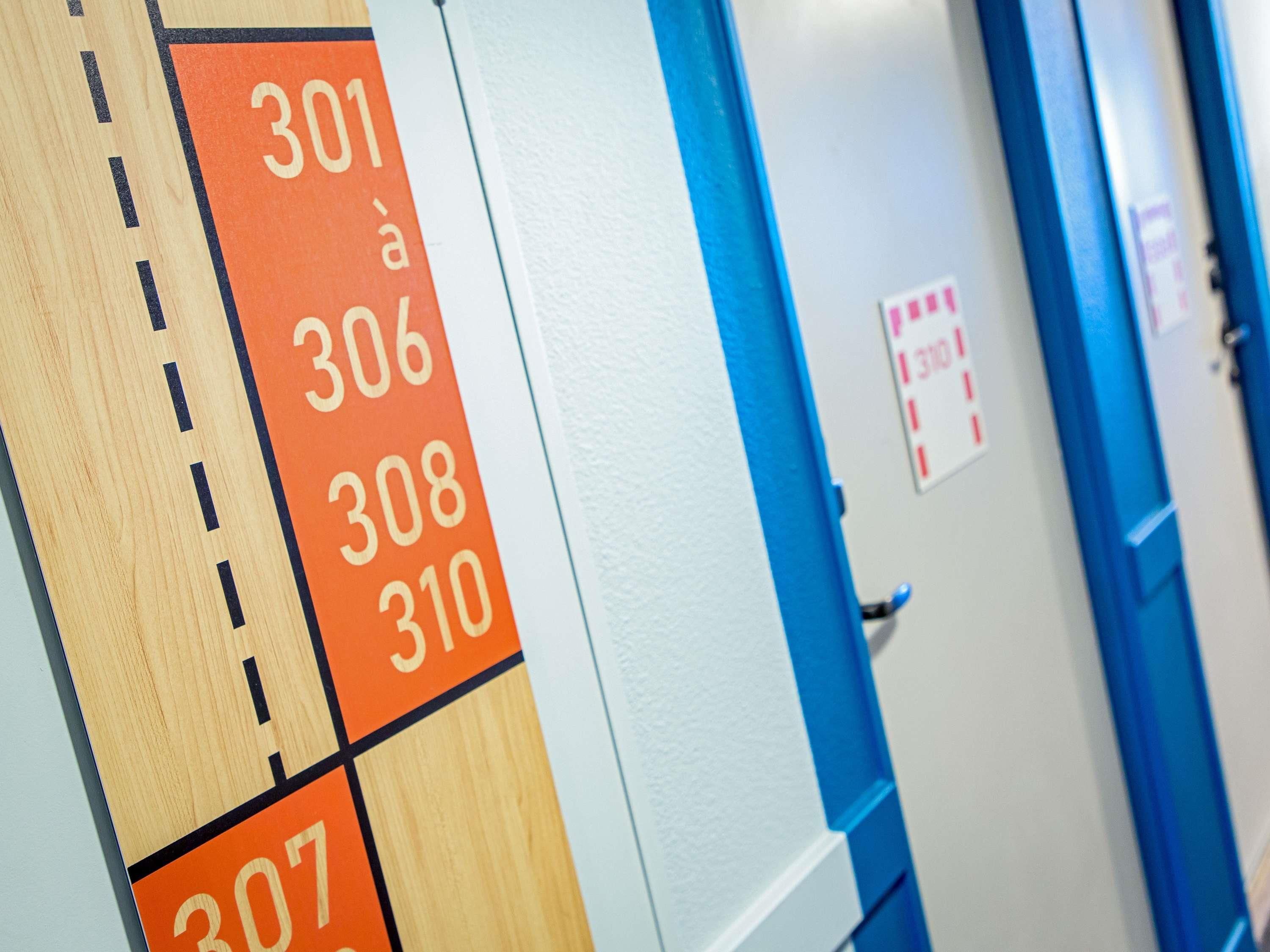 A hallway with numbered doors, indicating room numbers 301 to 310.