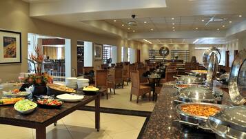 A buffet setup with various food stations and seating areas.