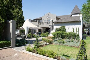 A building with a sign reading "one twenty restaurant" and a covered outdoor seating area.