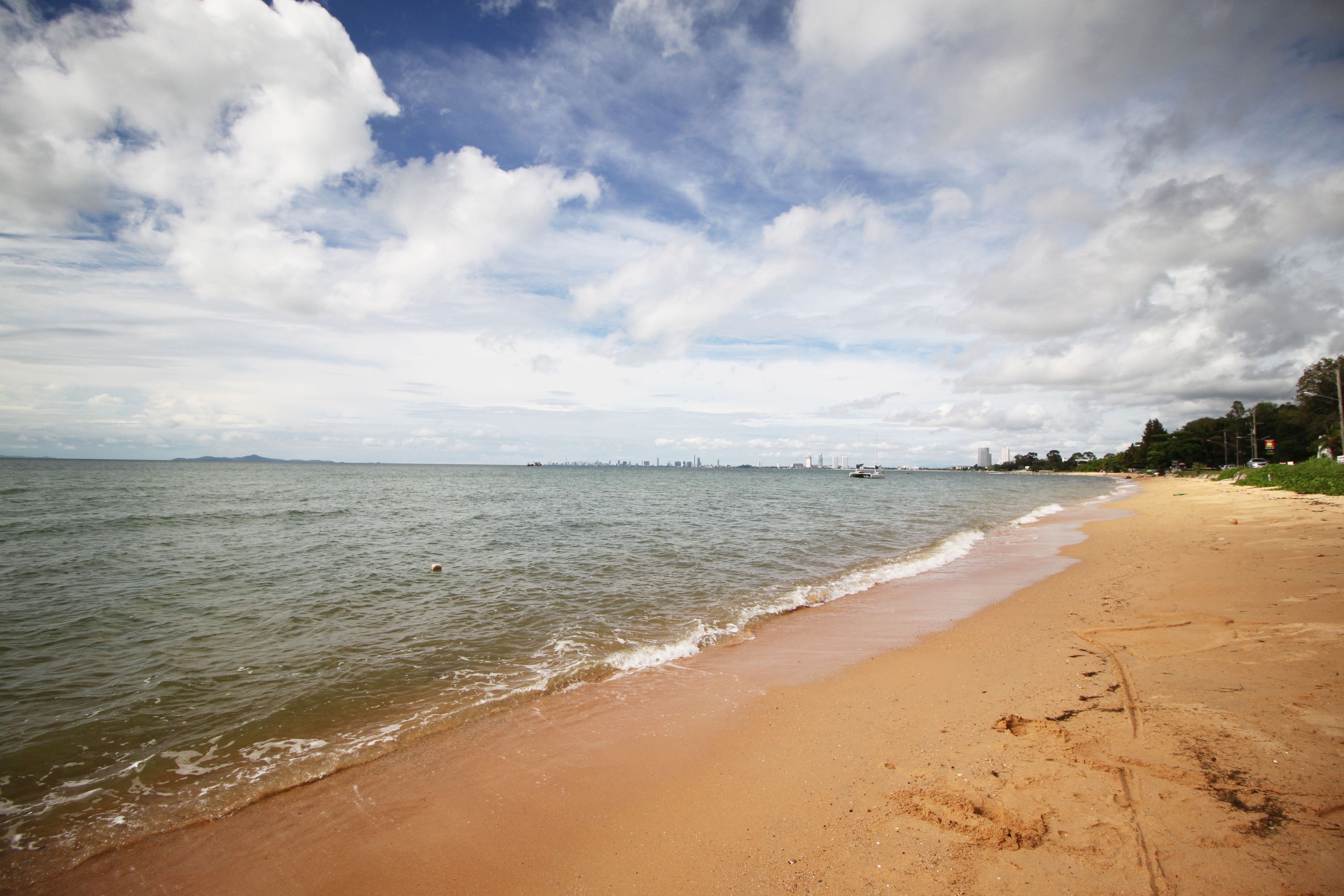 A beach with a sandy shore and calm water.
