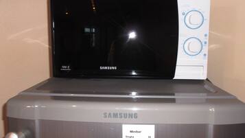 A Samsung microwave with a digital display and control panel.