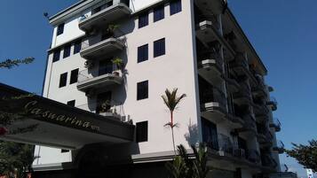 Experience the modern architecture of the Casuarina Hotel, featuring spacious balconies with potted plants.