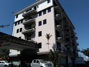 A multi-story hotel with balconies, a sign reading "Casuarina Hotel", and a parked car in front. - Casuarina Hotel (Kota Kinabalu)
