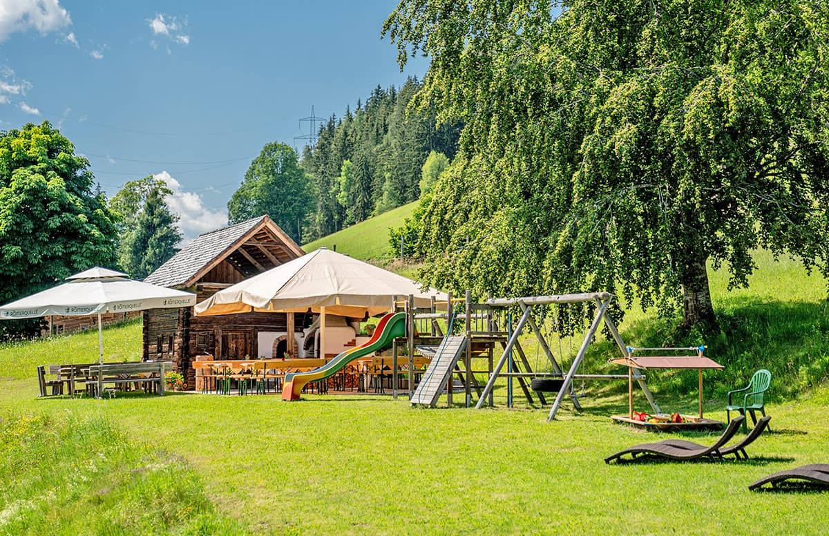 A lodge with outdoor seating, a play area, and a dining area.