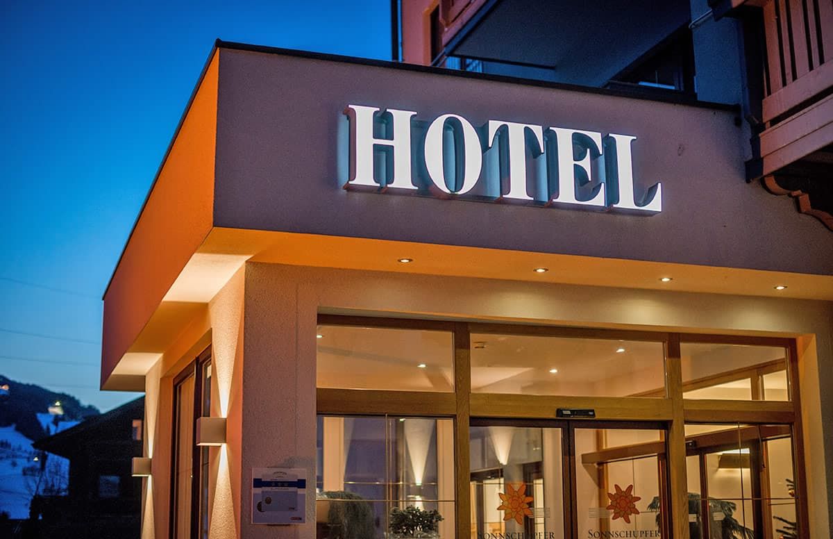 A hotel entrance with a prominent 'HOTEL' sign above the doors.