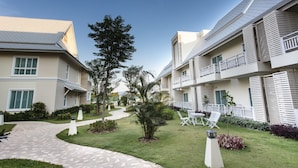 A modern hotel with a central courtyard, outdoor seating, and a well-maintained garden. - Nantrungjai Boutique Hotel (Nan)